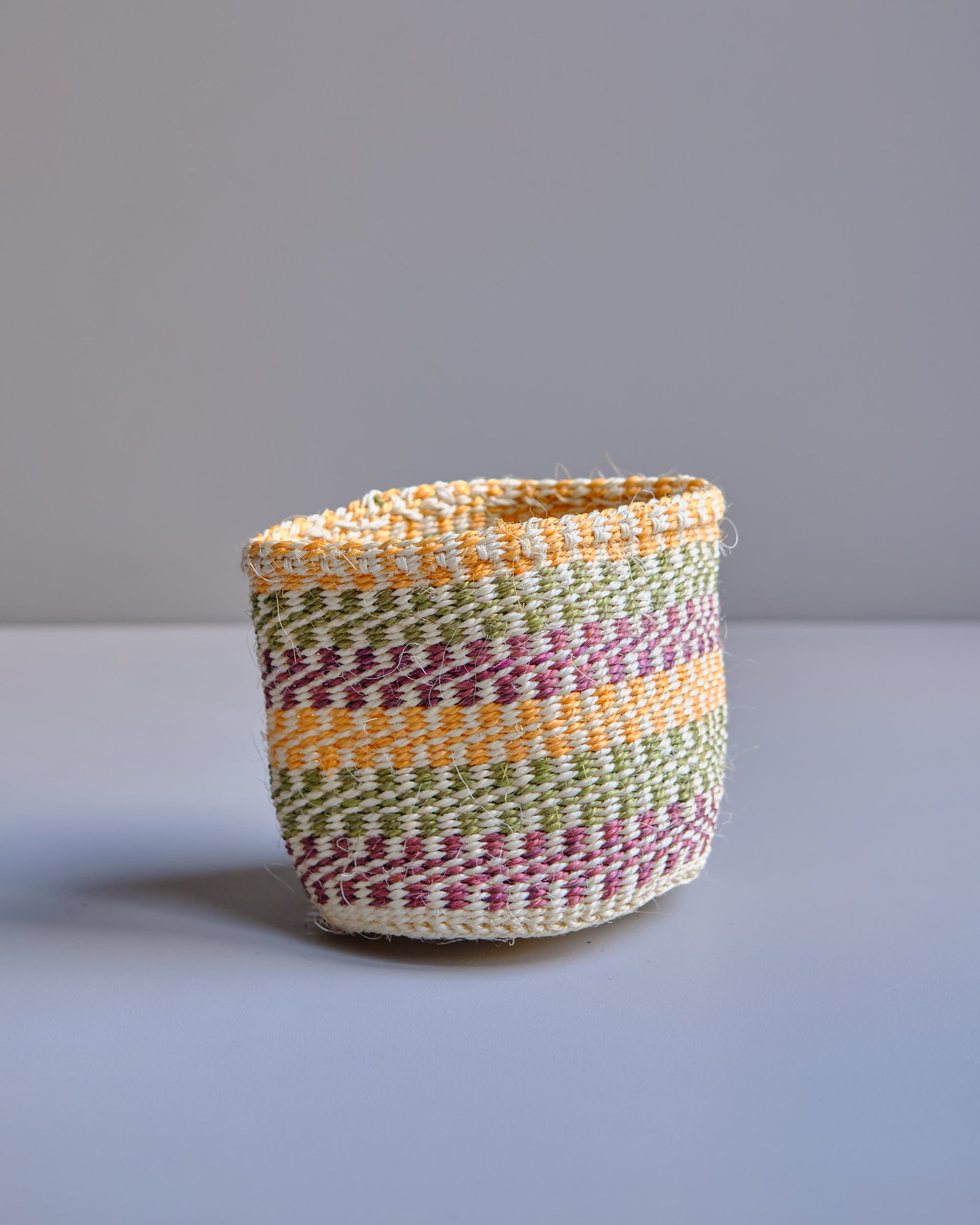Neutral Tones hand woven Kenyan Sisal Basket with yellow green and pink 
